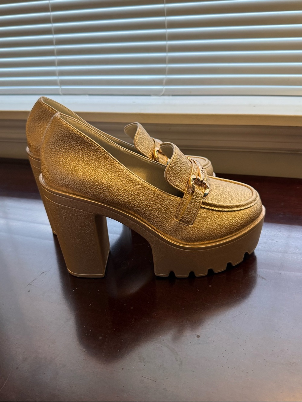 Gold chunky heels with gold buckle.